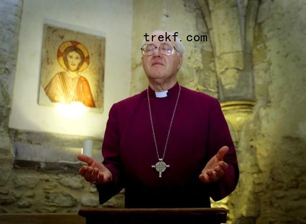 A file photograph shows George Carey leading a ceremony of prayer in the Crypt Chapel at his official residence in central London, on October 5, 2001. — Reuters pic