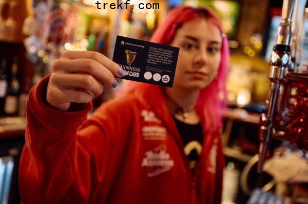 A member of staff holds up a ‘Guinness Ration Card’ behind the bar inside The Old Ivy House public house in Clerkenwell, Lo<em></em>ndon December 15, 2024. — AFP pic