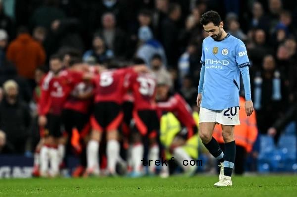 Manchester City<em></em>'s midfielder Bernardo Silva reacts as Manchester United<em></em>'s midfielder Amad Diallo celebrates scoring the team<em></em>'s second goal during the English Premier League football match between Manchester City and Manchester United at the Etihad Stadium in Manchester, north west England, on December 15, 2024. — AFP pic