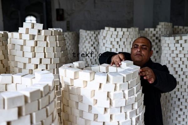 A man arranges stacks of soap at a local soap factory in the old city of Nablus, in the occupied West Bank November 28, 2024. — AFP pic