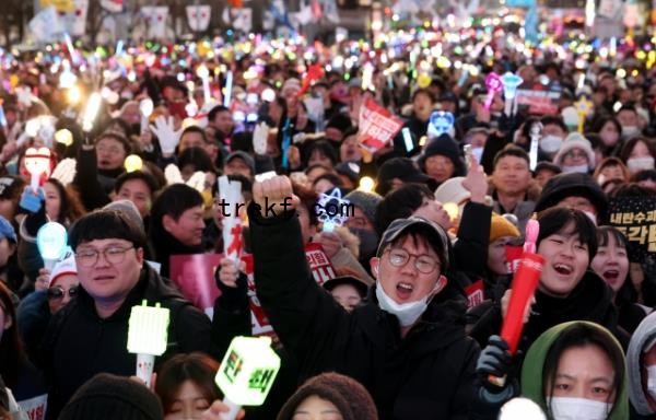 Protesters gather near the Natio<em></em>nal Assembly in Seoul on Dec. 14, 2024, celebrating the passage of an impeachment motion against President Yoon Suk Yeol. (Yonhap)